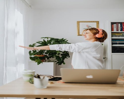 A person taking a physical stretch break during active home office work